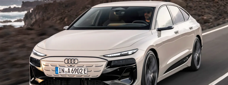 The 2025 Audi A6 eTron driving on a coastal road.