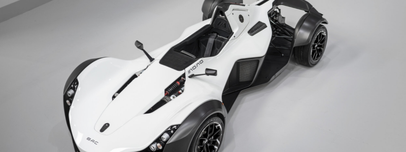 An overhead view of a white and black BAC Mono on a grey surface.