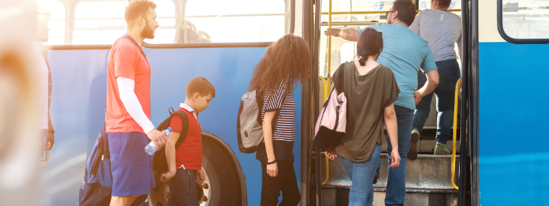 People boarding a bus, representing public transport.