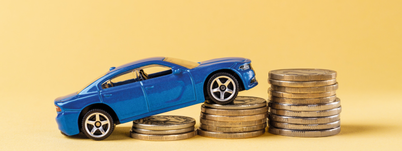 A blue toy car on a stack of coins growing in size from left to right, showing increasing car costs.