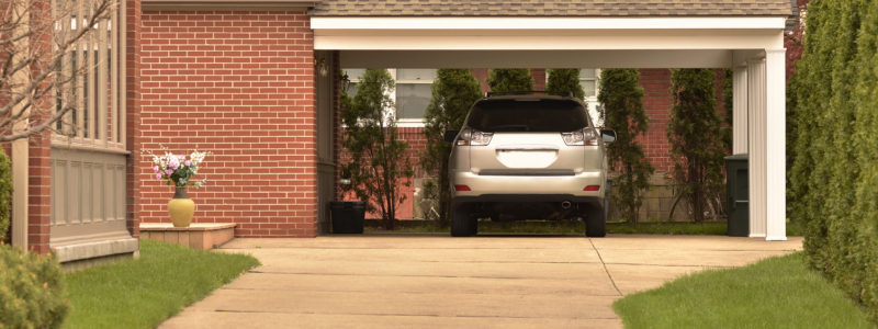 An SUV parked outside a house down a private driveway, representing off-road parking.