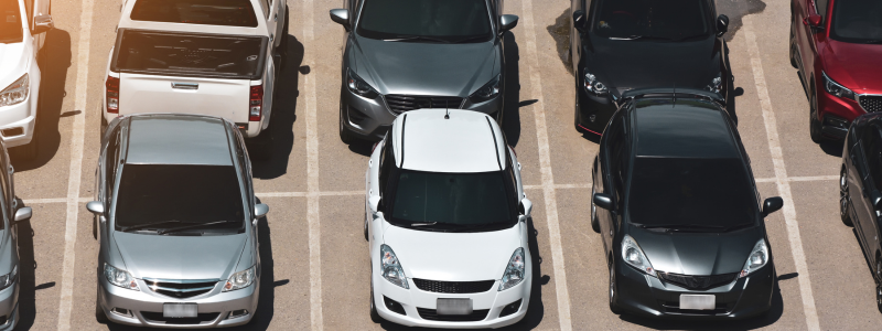 Rows of cars parked up, all filled with cars.