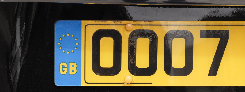 A close-up of a car number plate with '0007' written on it.