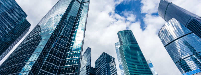 An upward shot of tall skyscrapers in the daytime.