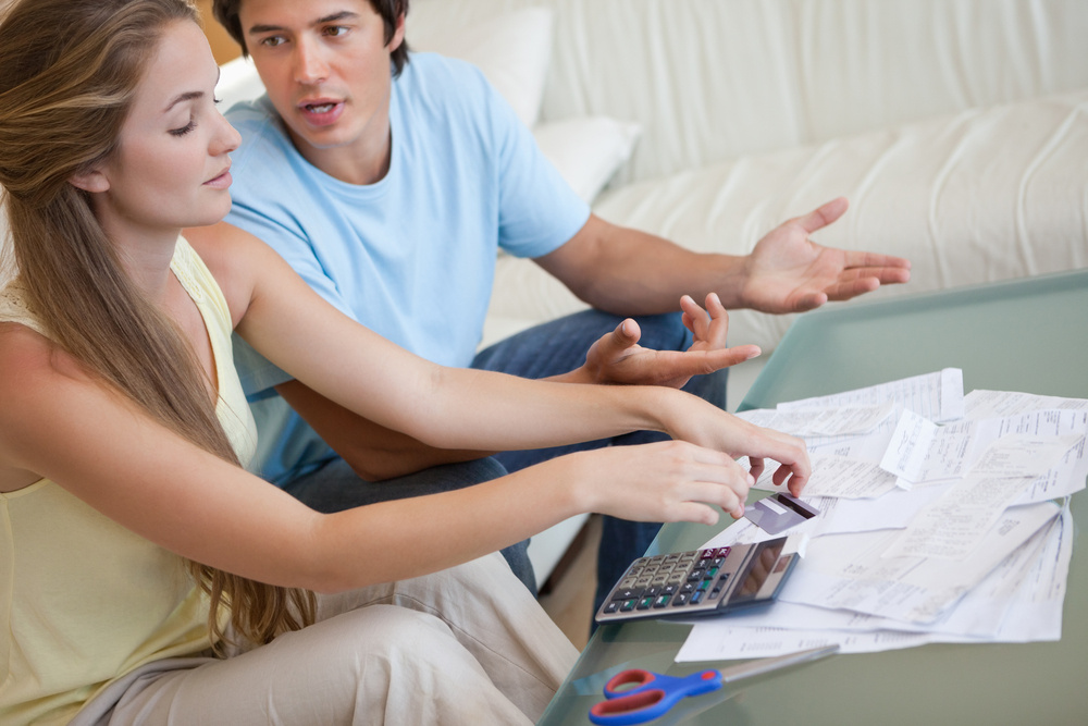 Couple having an argument about their bills in their living room