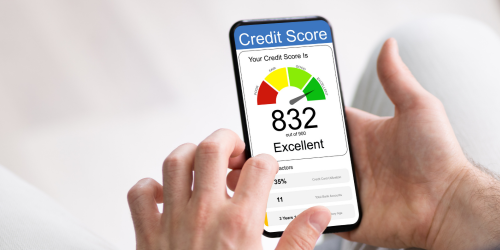 Hands holding a phone that displays an excellent credit score, symbolising credit checks.