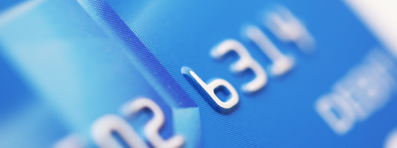 An extreme close up of a blue debit card.