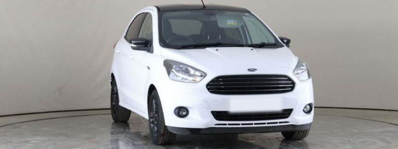 A white Ford Ka parked against a grey backdrop, likely in a car showroom.