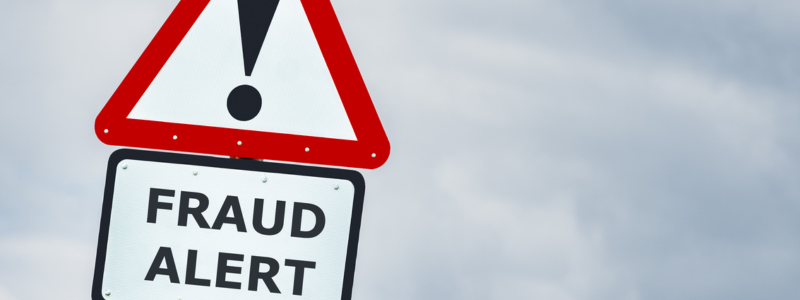 A warning sign with 'FRAUD ALERT' written on it, symbolising fraud detection.