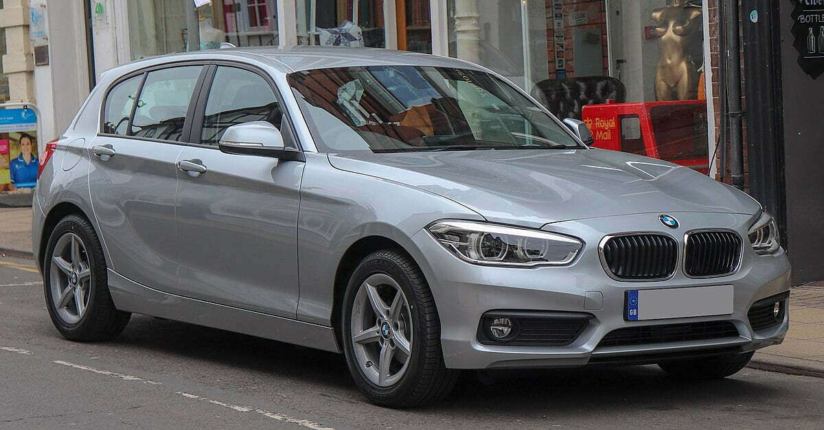 A grey BMW 1 Series parked on the side of the road.