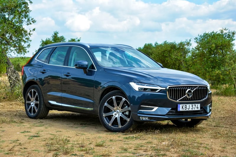 A Volvo XC60 parked up in a countryside setting.