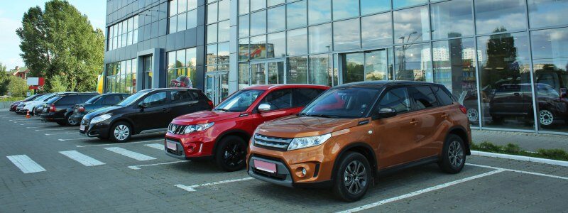 Cars parked outside of a car dealership