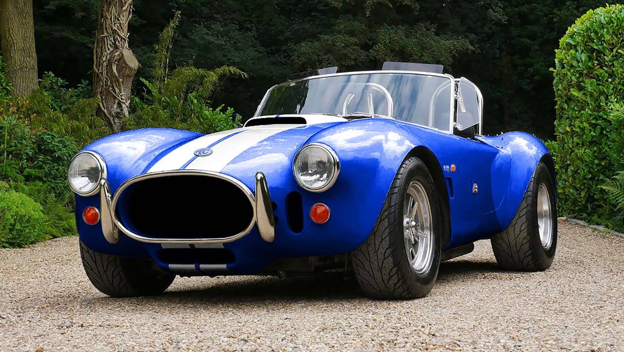 The AC Cobra EV+ parked in orange with black stripes.