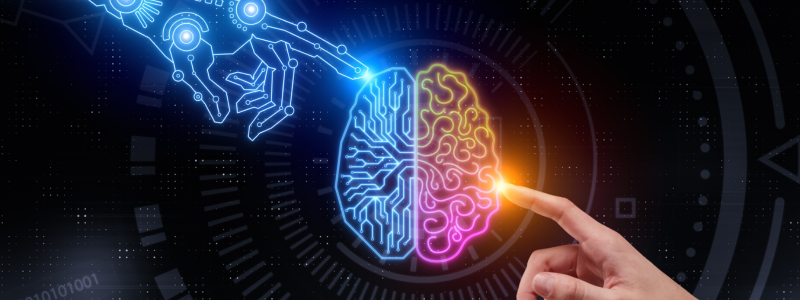 An image illustrating the fusion of technology and human intelligence, featuring a robotic hand and a human hand touching a neon-lit brain, symbolising artificial intelligence.