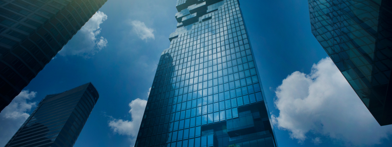 An upward view of buildings going up into the sky.