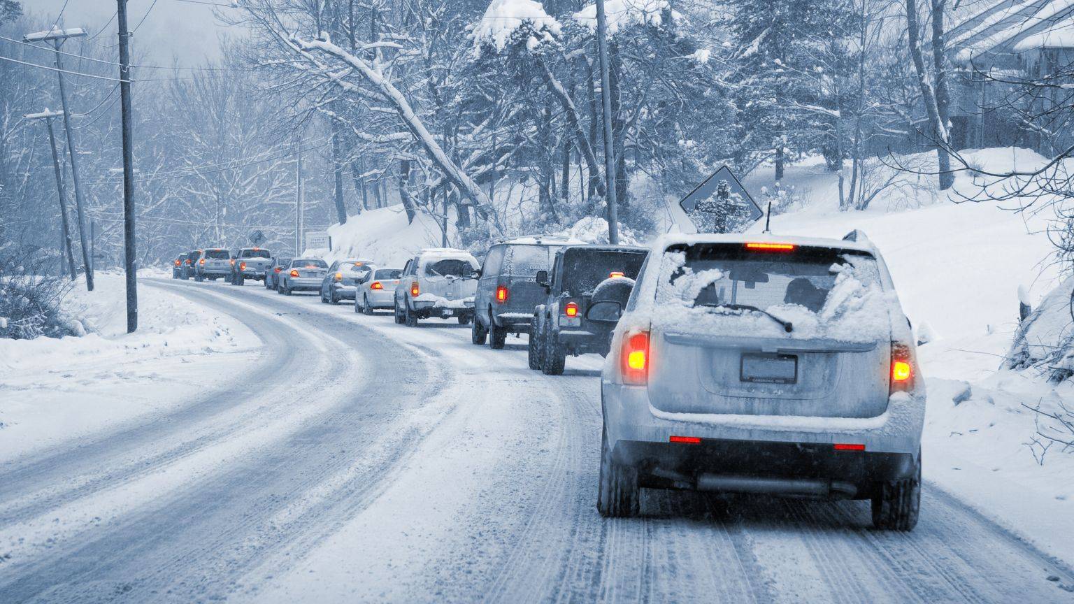 A queue of cars driving in the snow