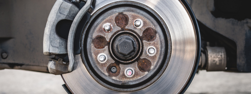 A close up of an exposed car tyre frame with the brakes attached.