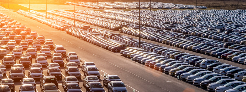 An overhead image of a large lot of cars parked up.