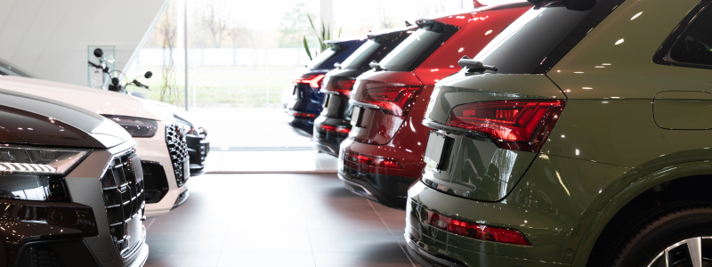 Two rows of cars in a car showroom.