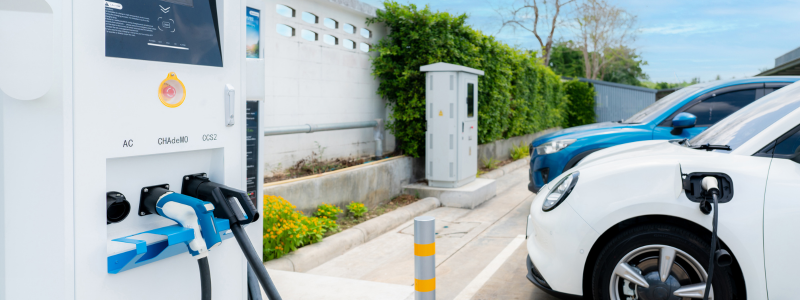 A close up of an electric charging point with a car plugged in.