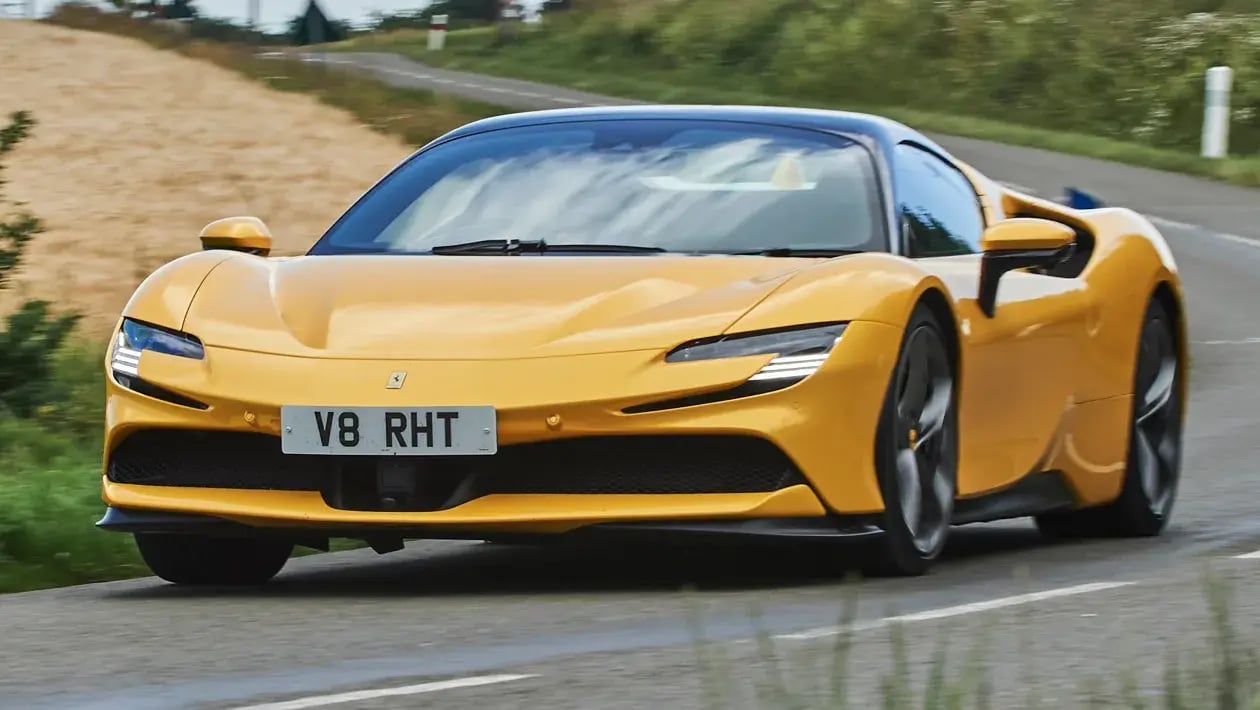 The Ferrari SF 90 Spider in yellow on a road.