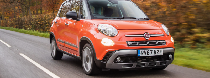 An orange Fiat 500L on a road.