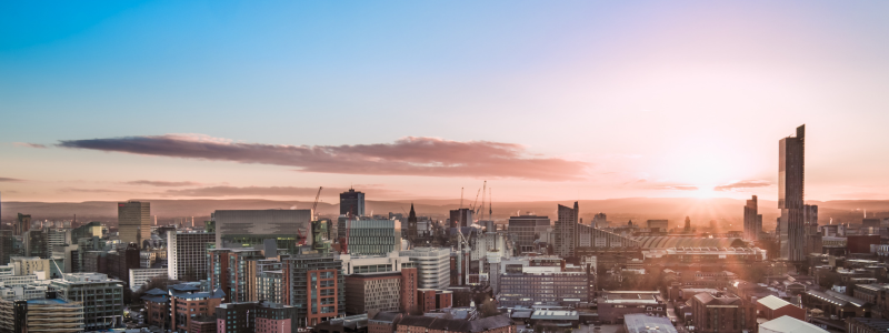 The Manchester skyline with sun shining.