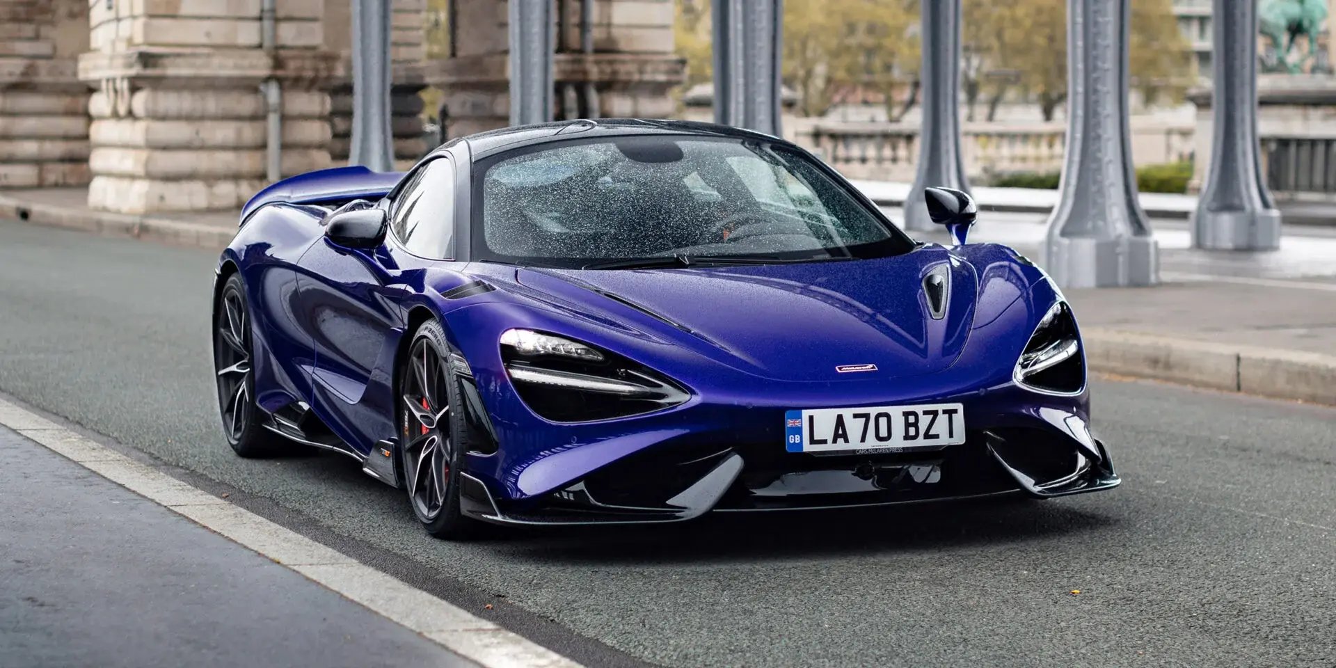 The McLaren 765LT Spider in red on a race track.