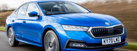 A blue Skoda Octavia driving on a road.