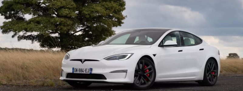 A Tesla Model S parked in a rural location.