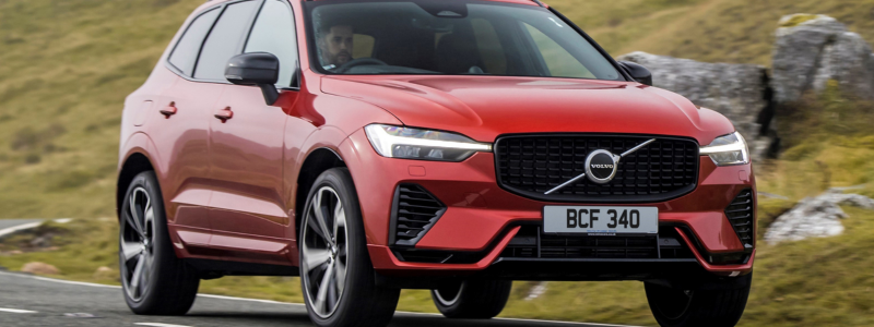 An orange Volvo XC60 on a road.