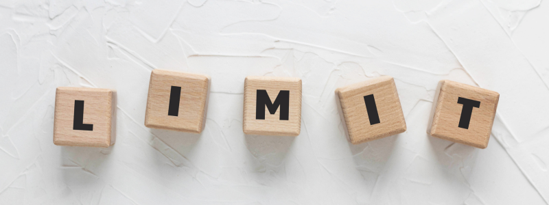 Lettered dice lined up spelling out 'LIMIT'.