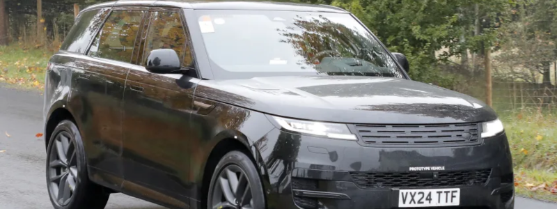 The 2025 Range Rover EV in black on a road.