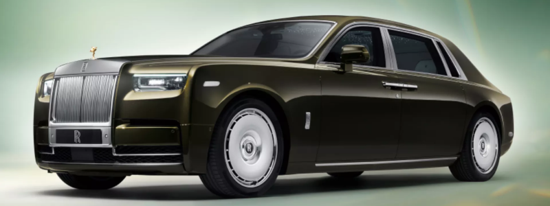 Elegant dark green Rolls-Royce luxury sedan set against a gradient background, highlighting its sophisticated design and premium craftsmanship