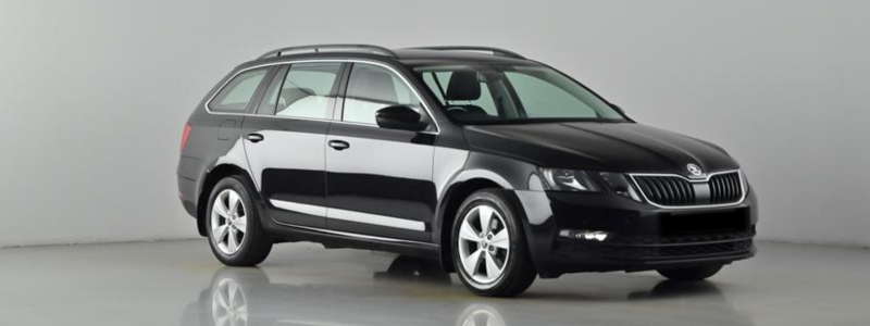 A black Skoda Octavia parked against a grey background, likely in a car showroom.