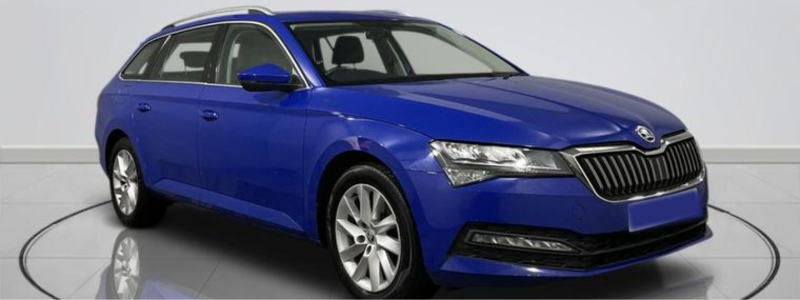 A blue Skoda Superb parked side-on in a car showroom.