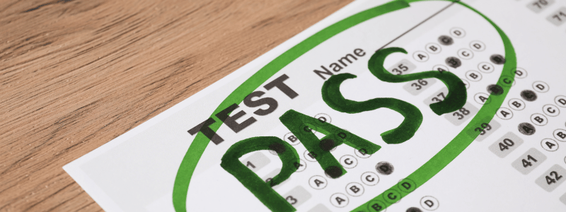 A test sat on a table, with pass written in green capital letters at the top, showing that the test was passed.