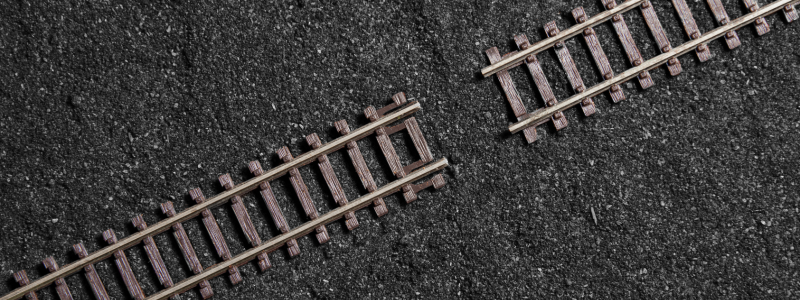 An overhead shot of train tracks with a gap between them.