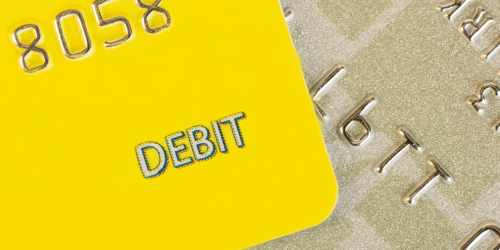 A close up picture of a yellow debit card.